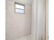 Shower area with tiled walls, shower curtain, window, and white tile floor at 2569 Tandori Cir, Orlando, FL 32837