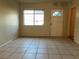 Bright living room with tile floors, a front window, and direct access to the front door at 2619 Milton Ave, Kissimmee, FL 34741