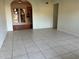 Spacious living room featuring tile flooring and a view into a sunroom through an archway at 2619 Milton Ave, Kissimmee, FL 34741
