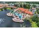 Aerial view of a resort-style pool area featuring pools, lounge chairs, slides, and water features at 2708 Camaro Dr, Kissimmee, FL 34746