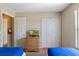 Bedroom featuring light wooden furniture, a TV on the dresser, closet and interior door at 2708 Camaro Dr, Kissimmee, FL 34746
