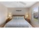 Bedroom with a large window, ceiling fan, carpet, queen bed, and side tables at 2708 Camaro Dr, Kissimmee, FL 34746