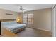 Bedroom with a large window with blinds, ceiling fan, carpet, queen bed, and side tables at 2708 Camaro Dr, Kissimmee, FL 34746