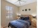 Comfortable bedroom with a queen bed, neutral walls, and a window overlooking the community at 2708 Camaro Dr, Kissimmee, FL 34746