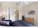 Neutral bedroom featuring a dresser, closet, tv and comfortable queen bed with a view of the exterior at 2708 Camaro Dr, Kissimmee, FL 34746