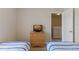 Bedroom features two twin beds, a dresser with a TV, carpet, and a window at 2708 Camaro Dr, Kissimmee, FL 34746