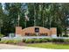 A welcoming entrance sign reads Regal Oaks, with flags, a fountain, and landscaping at 2708 Camaro Dr, Kissimmee, FL 34746