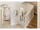 Inviting home entryway leading to the main living areas, featuring tile flooring and a staircase to the upper level at 2708 Camaro Dr, Kissimmee, FL 34746