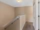Upstairs hallway featuring carpeted flooring, and a utility closet at 2708 Camaro Dr, Kissimmee, FL 34746