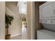 Conveniently located laundry closet situated adjacent to stairs, complete with a stacked washer and dryer setup at 2708 Camaro Dr, Kissimmee, FL 34746