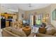 Comfortable living room with open kitchen and sliding glass doors to the backyard at 2708 Camaro Dr, Kissimmee, FL 34746