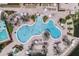 Aerial view of a resort-style pool with palm trees and lounge chairs at 2708 Camaro Dr, Kissimmee, FL 34746