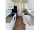Efficient kitchen with granite countertops, modern appliances, and ample cabinet space at 329 N Hart Blvd, Orlando, FL 32835