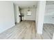 Open-concept living area showcasing wood-look floors, neutral paint, and seamless flow to the kitchen at 329 N Hart Blvd, Orlando, FL 32835