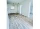 Bright and airy living room featuring wood-look flooring, neutral walls, and ample natural light at 329 N Hart Blvd, Orlando, FL 32835