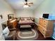 Comfortable bedroom with ceiling fan, accent pillows, wood furniture, and matching decor at 3407 Santa Monica Dr, Orlando, FL 32822