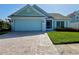 Charming single-story home with a paved driveway, attached garage, and well-maintained lawn at 3407 Santa Monica Dr, Orlando, FL 32822