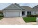 Charming single-story home with a brick driveway and attached two-car garage, plus manicured lawn and garden at 3407 Santa Monica Dr, Orlando, FL 32822