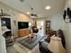 Inviting living room with ceiling fan, leather sofa, rocking chair, display case, and recessed lighting at 3407 Santa Monica Dr, Orlando, FL 32822