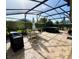 Screened patio with umbrella table, furniture, grill, and hot tub at 3407 Santa Monica Dr, Orlando, FL 32822