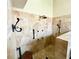 Stylish travertine tile shower with multiple shower heads, handheld sprayer, and built-in bench at 3407 Santa Monica Dr, Orlando, FL 32822