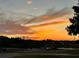Scenic sunset sky with trees in the background and a view of the neighborhood at 3407 Santa Monica Dr, Orlando, FL 32822