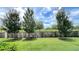 Well-maintained backyard featuring a lush green lawn, privacy fence, and mature trees at 4634 Tribute Trl, Kissimmee, FL 34746