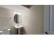 Clean half-bathroom with a pedestal sink, toilet, and modern lighting fixture at 4634 Tribute Trl, Kissimmee, FL 34746