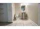 Bright bathroom featuring a pedestal sink and neutral tile flooring at 4634 Tribute Trl, Kissimmee, FL 34746