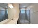 Bathroom featuring a glass-enclosed shower and a vanity with ample countertop space, creating a relaxing environment at 4634 Tribute Trl, Kissimmee, FL 34746