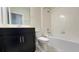 Well-lit bathroom featuring a black vanity with chrome hardware and a shower-tub combo at 4634 Tribute Trl, Kissimmee, FL 34746