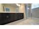 Spacious bathroom with double vanity, tiled floors, and a glass-enclosed shower, perfect for a modern lifestyle at 4634 Tribute Trl, Kissimmee, FL 34746