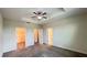 Carpeted main bedroom with ceiling fan and multiple doors at 4634 Tribute Trl, Kissimmee, FL 34746