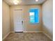 Neutral entryway features a front door, window with blinds, and tiled flooring at 4634 Tribute Trl, Kissimmee, FL 34746