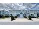 Street view of attractive light blue two-story townhomes, each with individual garages and paved driveways at 4634 Tribute Trl, Kissimmee, FL 34746