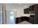 Modern kitchen features stainless steel appliances, dark cabinets, and white countertops at 4634 Tribute Trl, Kissimmee, FL 34746