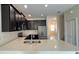 Spacious kitchen with modern appliances, dark cabinets, and a view of the stairway at 4634 Tribute Trl, Kissimmee, FL 34746