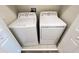 Laundry room with side-by-side washer and dryer units and ample space for efficient laundry management at 4634 Tribute Trl, Kissimmee, FL 34746