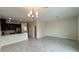 Open concept living space with a view of the kitchen and sliding glass doors to the backyard at 4634 Tribute Trl, Kissimmee, FL 34746
