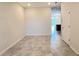 Neutral living room with tile flooring opening to the dining and kitchen area at 4634 Tribute Trl, Kissimmee, FL 34746