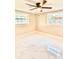 Bright bedroom features new tile floor, ceiling fan and two windows at 4917 Easton St, Lake Wales, FL 33859