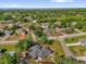 Aerial view of a home surrounded by green trees with views of a scenic lake at 511 Mobley Dr, Deltona, FL 32725