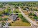 An aerial view showcases the home with mature trees, landscaped yard and defined property lines at 511 Mobley Dr, Deltona, FL 32725