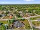 This aerial showcases the property lines of a home amid lush greenery, bordering a lake at 511 Mobley Dr, Deltona, FL 32725
