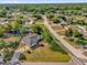 An aerial view showcases the home with mature trees, landscaped yard and defined property lines at 511 Mobley Dr, Deltona, FL 32725