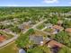 Aerial view of a home nestled in a lush, wooded neighborhood with a lake nearby at 511 Mobley Dr, Deltona, FL 32725