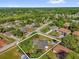 Aerial view of a home nestled in a lush, wooded neighborhood with a lake nearby at 511 Mobley Dr, Deltona, FL 32725