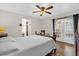 Bright bedroom featuring wood-look floors, a door to the patio, and ensuite bathroom access at 511 Mobley Dr, Deltona, FL 32725
