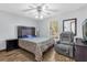 Cozy bedroom featuring a comfy recliner, wood-look floors, and a ceiling fan at 511 Mobley Dr, Deltona, FL 32725