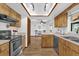 Well-lit kitchen with stainless steel appliances and an open layout to a dining area at 511 Mobley Dr, Deltona, FL 32725
